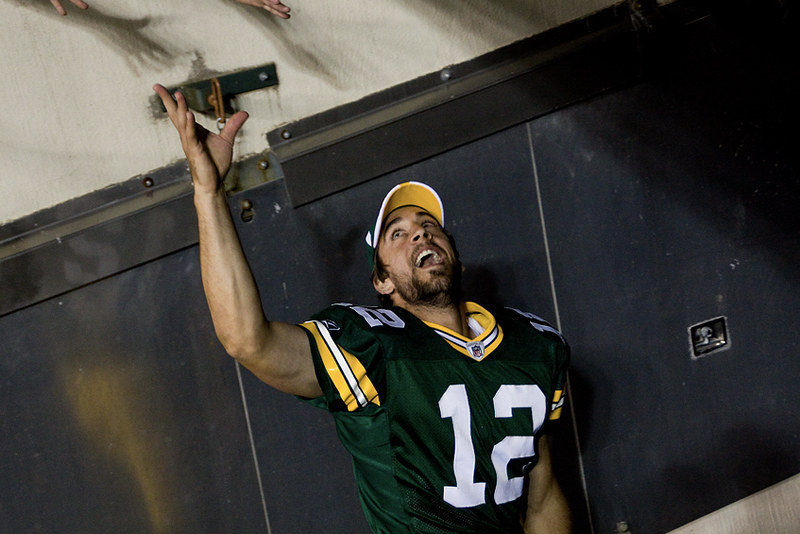 Green Bay Packers starting quarterback Aaron Rodgers runs off Lambeau Field into the tunnel amid a standing ovation.
